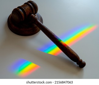 Judicial Gavel On A Table With A Rainbow Light Prism. 