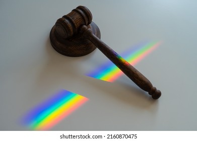 Judicial Gavel On A Table With A Rainbow Light Prism. 