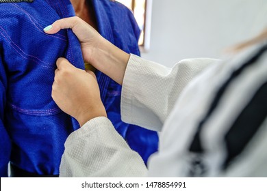 Judo BJJ Brazilian Jiu Jitsu Grip Female Fighter Gripping Hold Kimono Gi Lapel In A Fight Training Sparring