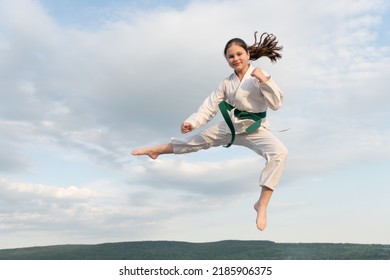 Judo Concept. Teen Girl Practicing Judo. Girl Judo Fighter On Sky Background