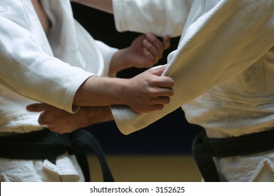 Judo Fighters Sparring Off In A Battle Of Body And Mind - Selective Focus And Visible Grain