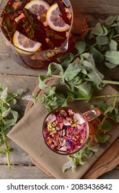 Jug And Cup With Floral Tea On Wooden Background