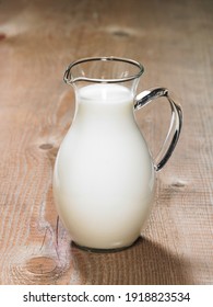 Jug Of Milk On Wooden Table