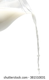 A Jug Pouring Milk On Isolate White Background. Milk Splash