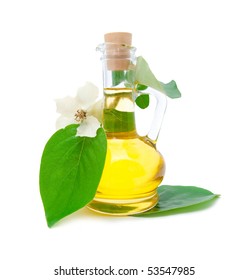 Jug With Vegetable Oil And A Beautiful White Flower On A Branch