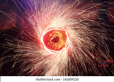 A Juggler Creates A Circular Painting With Sparkling Pois. The Drawing Looks Like Fictional Teleportation Door