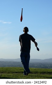 Juggler On A Hill Top At Dusk