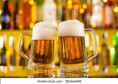 Jugs Of Beer Placed On Bar Counter