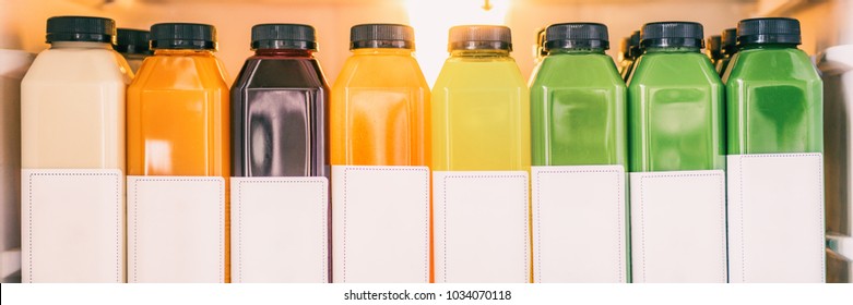 Juice bottles for detox cleanse juicing trend - Healthy diet food delivery at home in fridge banner panorama. Selection of cold press vegetable and fruit juices, orange, lemon, beets, spinach.