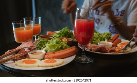Juice in a glass and breakfast - Shutterstock ID 2192542071