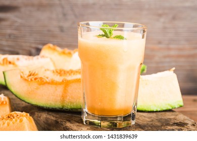 The juice of melon with mint in a glass jar on the table.Hami melon - Shutterstock ID 1431839639