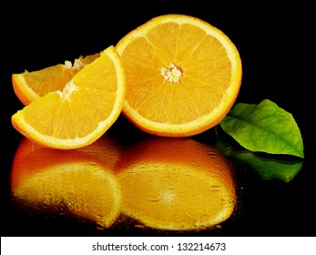 Juice Orange Fruit On A Black Background With Water Drops