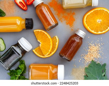 Juice shots for a healthy lifestyle, flat lay on dark grey with ingredients - Shutterstock ID 2248425203