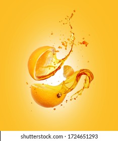 Juice splashes out from sliced orange on a yellow background