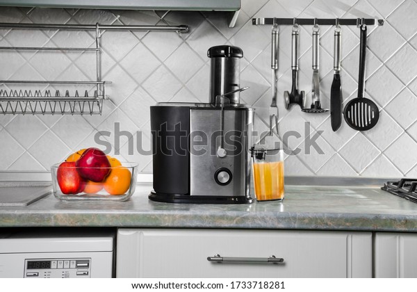 juicer\
for fruits and vegetables on the kitchen table. small household\
appliances for the home. modern kitchen\
interior