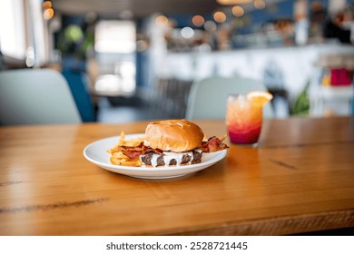 A juicy burger with crispy fries, held in a person's hands. The burger bun is slightly open, revealing delicious toppings. Perfect for fast food, comfort food, and restaurant menus - Powered by Shutterstock