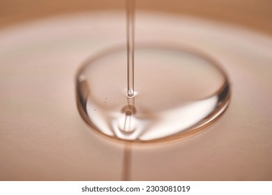 A juicy drop of gel on a beige background. - Shutterstock ID 2303081019
