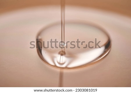 A juicy drop of gel on a beige background.