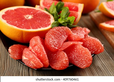 Juicy grapefruit pieces with fresh mint in a bowl, close up - Powered by Shutterstock