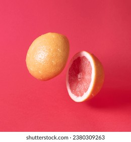 Juicy grapefruit slices levitating and facing each other in motion on the bold red background. Minimal citrus art direction. Tropical summer design. - Powered by Shutterstock