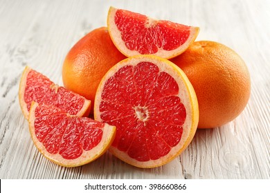 Juicy grapefruits on wooden background