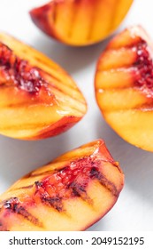 Juicy Grilled Nectarine Quarters On Light Gray Cutting Board.