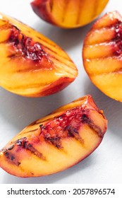 Juicy Grilled Nectarine Quarters On Light Gray Cutting Board.