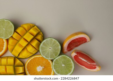 juicy healthy fresh fruit blend of citrus, orange, lime, grapefruit and tropical mango on a light beige background. for screensavers postcards covers signs inscriptions banners and much more - Shutterstock ID 2284226847