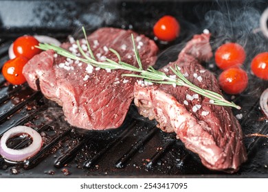 Juicy meat, the steak is grilled with cherry tomatoes, rosemary and coarse sea salt. High quality photo - Powered by Shutterstock