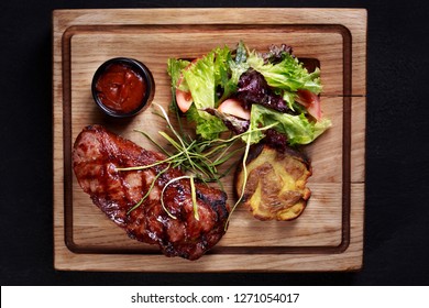 Juicy Medium Rare New York Steak, Striploin, Kansas, Strip Steak Served With Vegetable Salad And Potatoes On Board, Traditional American Cuisine, Grill And Barbeque, Meat Restaurant Menu