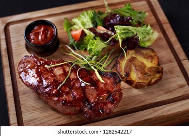 Juicy Medium Rare New York Steak, Striploin, Kansas, Strip Steak Served With Vegetable Salad And Potatoes On Board, Traditional American Cuisine, Grill And Barbeque, Meat Restaurant Menu