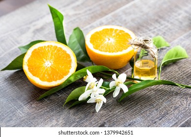 Juicy Orange Cut In Two Parts And Neroli, Flowers Of Orange Tree, On Rustic Wood Background. The Orange Blossom Is The Fragrant Flower Of The Citrus Is Used In Perfume And Tea, Aphrodisiac.