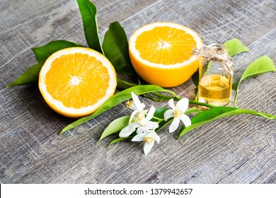 Juicy Orange Cut In Two Parts And Neroli, Flowers Of Orange Tree, On Rustic Wood Background. The Orange Blossom Is The Fragrant Flower Of The Citrus Is Used In Perfume And Tea, Aphrodisiac.