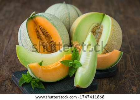 Juicy ripe melons on the wooden table