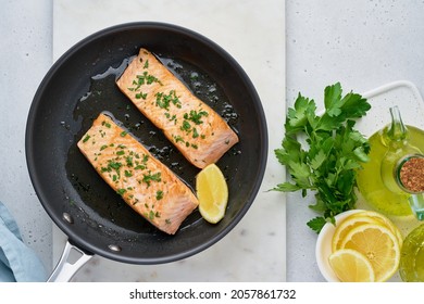 Juicy Salmon Fillet Fried On Pan With Parsley, Oil Olive And Lemon. Flavorful Pescetarian Meal. Healthy And Dietary Fish Dish Full Of Omega And Fats. Overhead, Horizontal