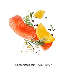 Juicy slice of fresh salmon with ingredients closeup isolated on a white background