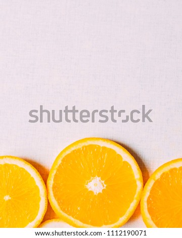 Juicy slices of an orange on a white, fruity background, top view. Vertical. Crop for instagram. Copy space for text