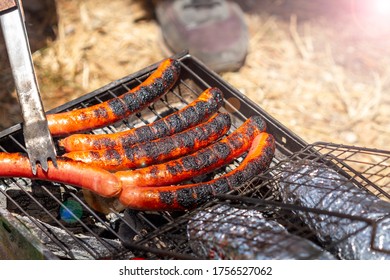 Juicy Slightly Burnt Sausages On The Grill. Picnic In The Nature.