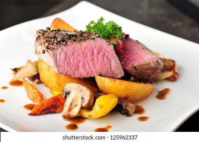 Juicy Steak With Baked Potatoes And Mushrooms, Dry Aged Prime Grade Beef Rib Eye Steak Cooked Medium Rare. Steak Cut Fries, Pepper, Mushrooms And Parsley On A Plate