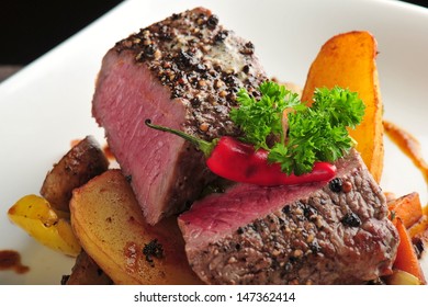 Juicy Steak With Baked Potatoes And Mushrooms, Dry Aged Prime Grade Beef Rib Eye Steak Cooked Medium Rare. Steak Cut Fries, Pepper, Mushrooms And Parsley On A Plate 