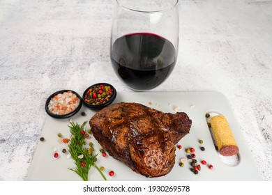 Juicy Thick Grilled Filet Mignon Steaks With Mixed Peppers, Sold And Herbs On The Cutting Board With Glass Of Wine On White Background