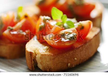 juicy tomatoes on fresh bread, pesto as topping