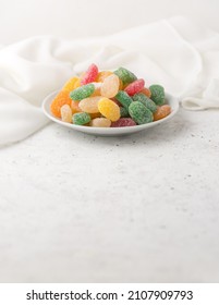 Jujube, Colorful Gummy Type Of Candy Confectionery On A White Plate, Taken In Shallow Depth Of Field With Copy Space