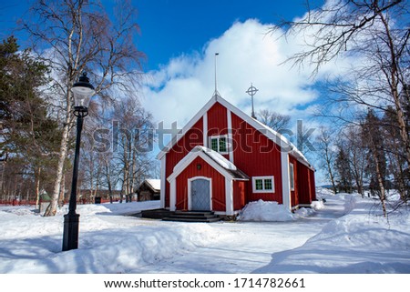 Jukkasjarvi Church, a Wooden red-colored church with a stand-alone bell tower in Swedish Lapland near Kiruna.