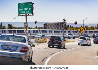 July 13, 2019 Hayward / CA / USA - Freeway Entrance In East San Francisco Bay Area; BART (Bay Area Rapid Transit) Train Passing In The Background