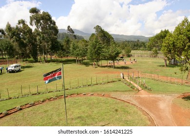 July 17th, 2014- Nairobi, Kenya: Kenyan School Children Holding Hands In A Circle In The Playground With The Kenyan Flag