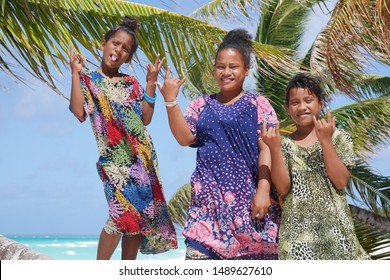 July 19, 2019. Marshallese Girls Posing In Front Of A Palm Tree On Arno Atoll In The Marshall Islands