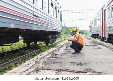 July 2018. Russia. Yelets. Railway Worker Inspects The Train