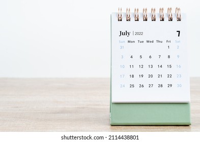 The July 2022 desk calendar on wooden background.