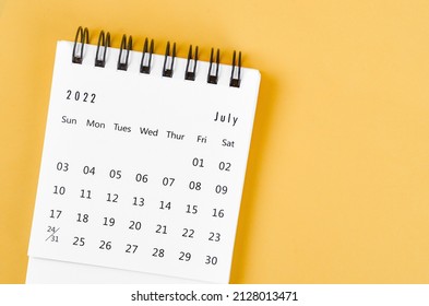 The July 2022 desk calendar on light yellow background. - Shutterstock ID 2128013471